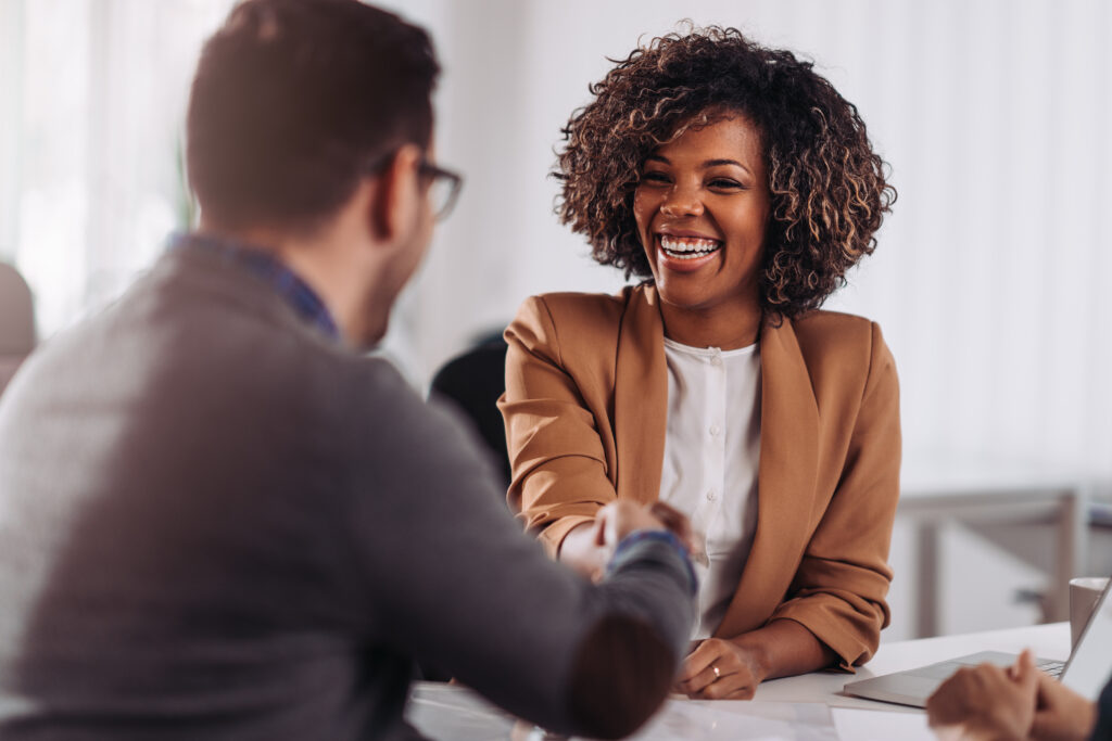 Business woman shaking hands with business man